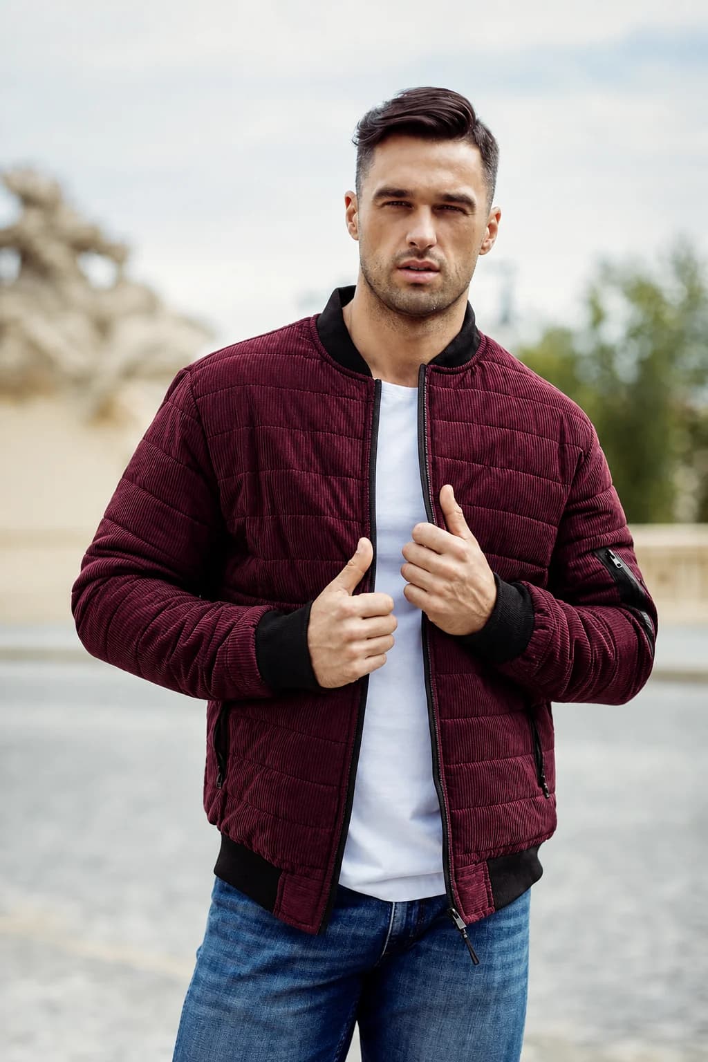 Male model wearing a burgundy quilted jacket outdoors