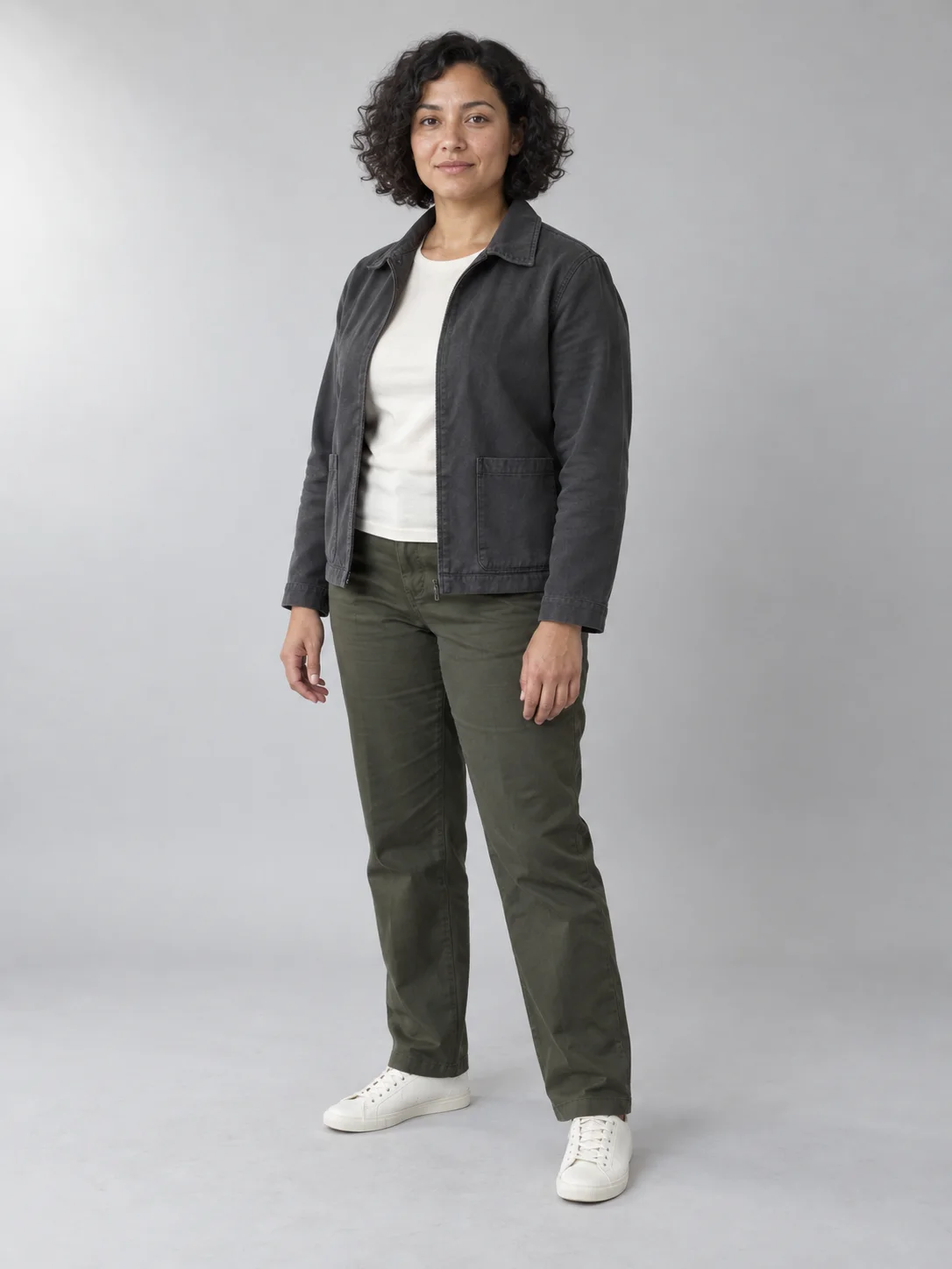 Synthetic full-body reference of a woman in a charcoal jacket, olive trousers, and off-white shoes